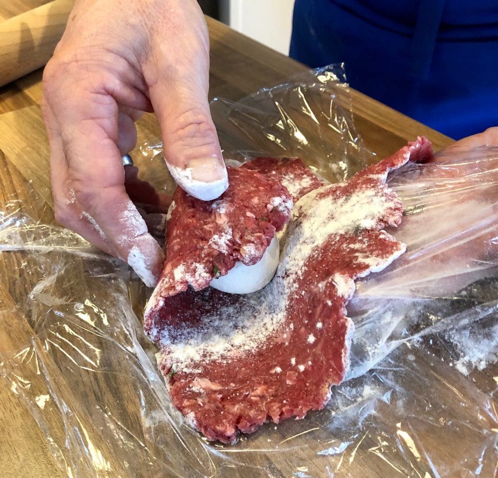 Carefully mould the rolled venison around each egg