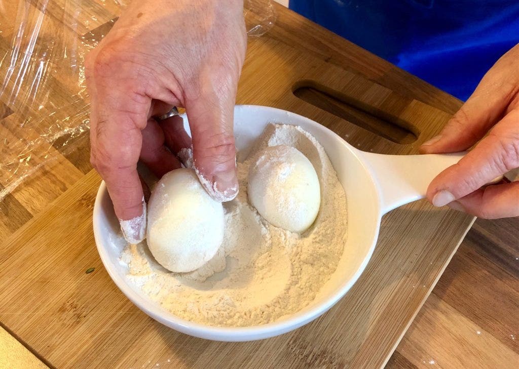 Rolling the eggs in seasoned flour helps the venison to stick to them