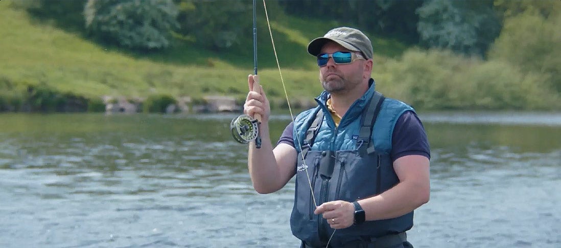 JT Makes A Fly Cast In A River, Fishing For Trout