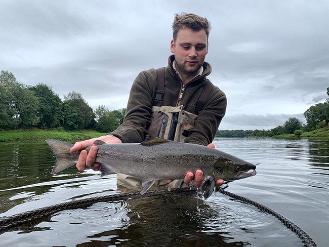 Jack with a stunning salmon catch Jack pictured with a lovely salmon whilst wading in the river