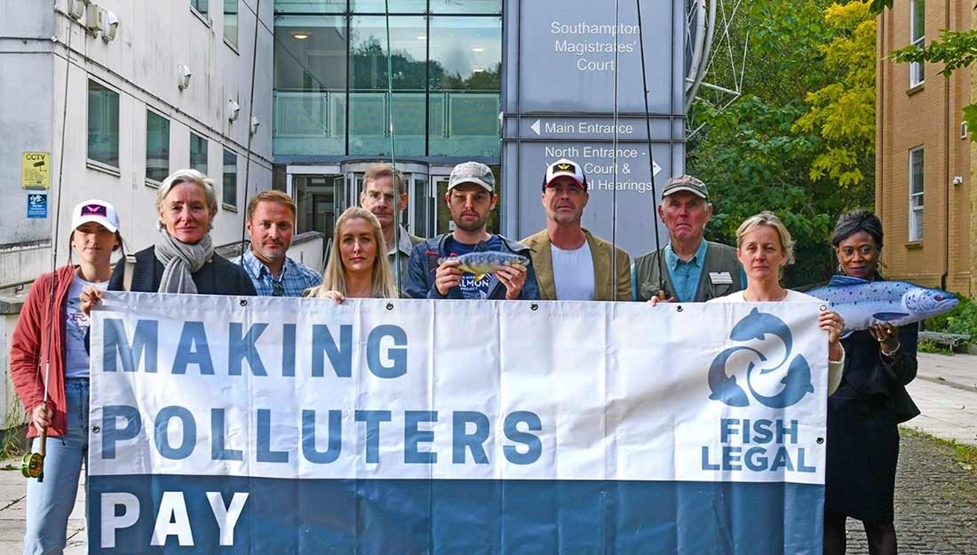Fish Legal outside the High Court Fish Legal holding up a banner saying Making Polluters Pay